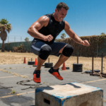 Athlete doing an explosive box jump during outdoor dryland training