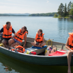 Family wearing life jackets on a small boat on a calm sunny lake