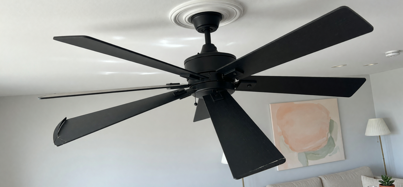 A modern matte black 52-inch ceiling fan mounted on a residential ceiling, illustrating the recalled Hampton Bay Halwin fans
