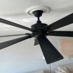 A modern matte black 52-inch ceiling fan mounted on a residential ceiling, illustrating the recalled Hampton Bay Halwin fans