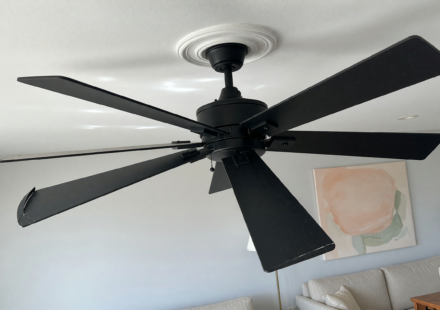 A modern matte black 52-inch ceiling fan mounted on a residential ceiling, illustrating the recalled Hampton Bay Halwin fans
