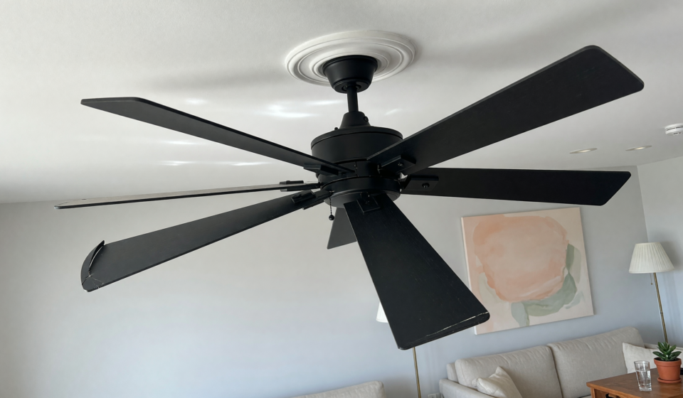 A modern matte black 52-inch ceiling fan mounted on a residential ceiling, illustrating the recalled Hampton Bay Halwin fans